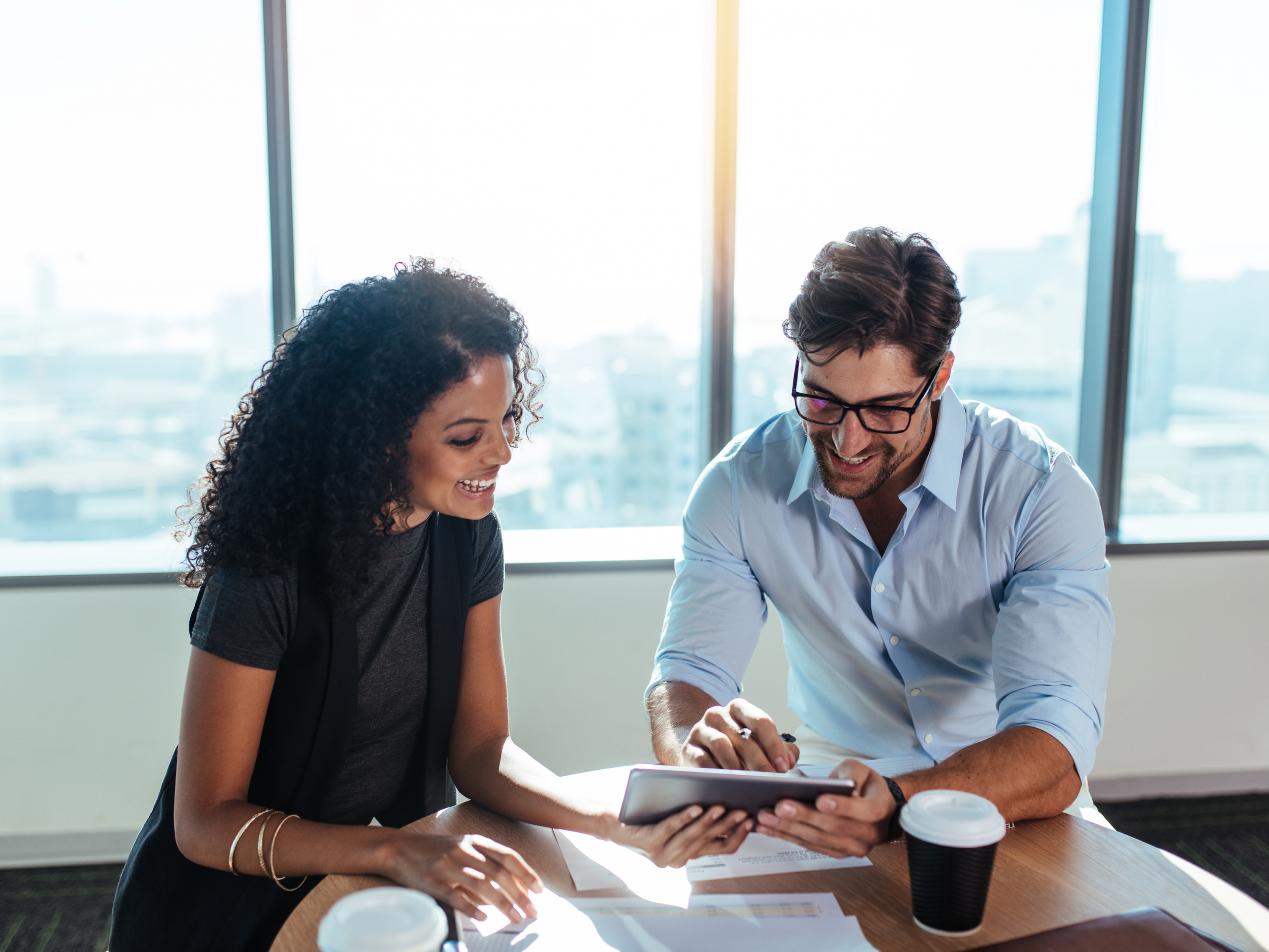 A man and a woman reviewing data, symbolizing the process of gathering information before making a purchase decision.